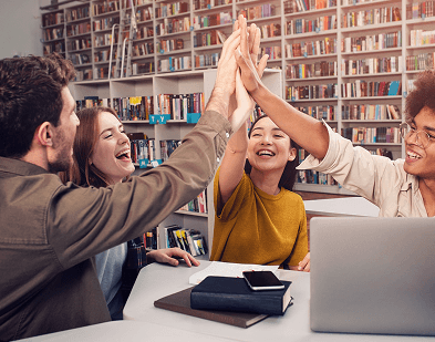 Group celebrating success in library.